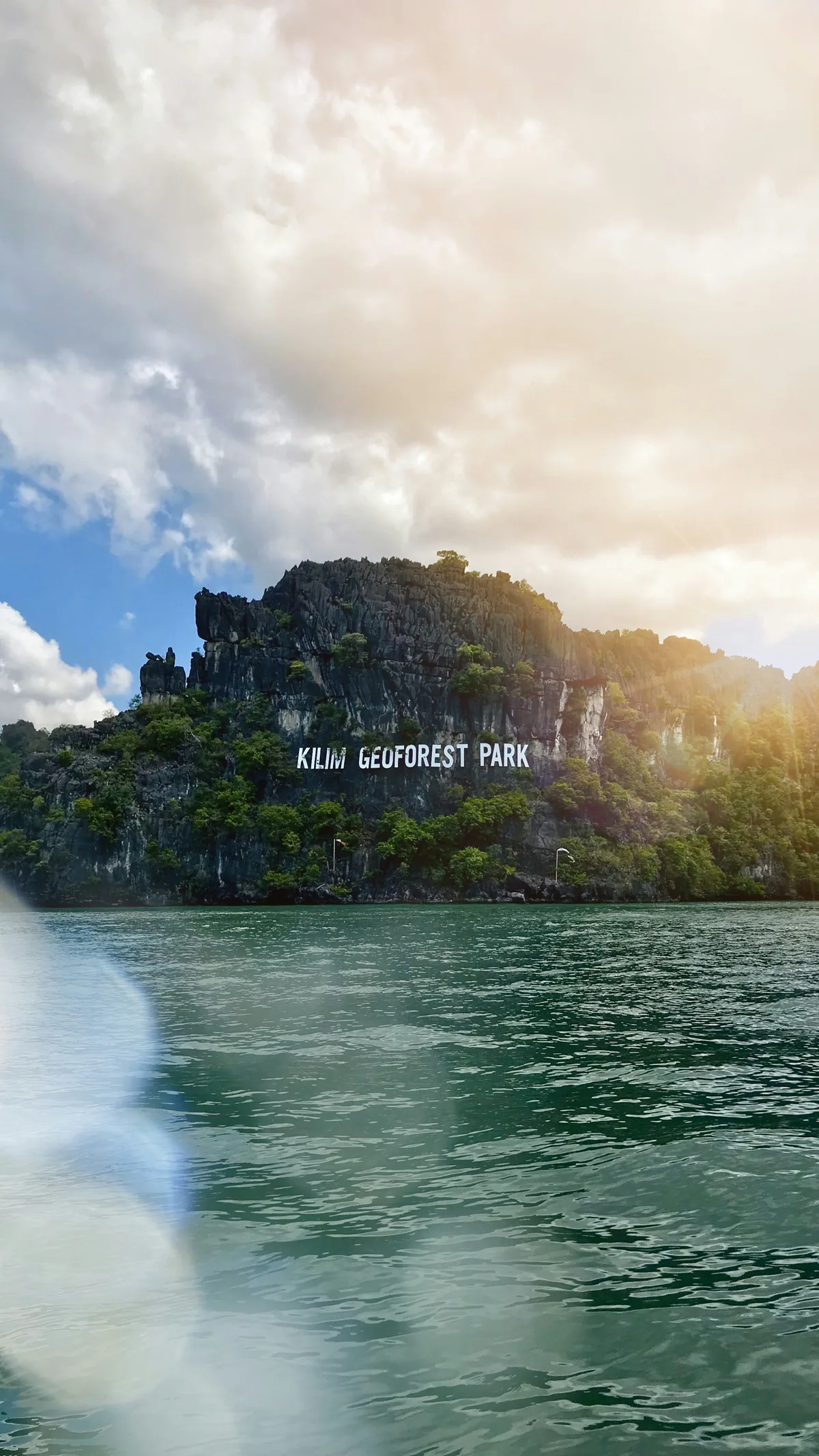Forested limestone rising above the water at Kilim Geoforest Park, Langkawi